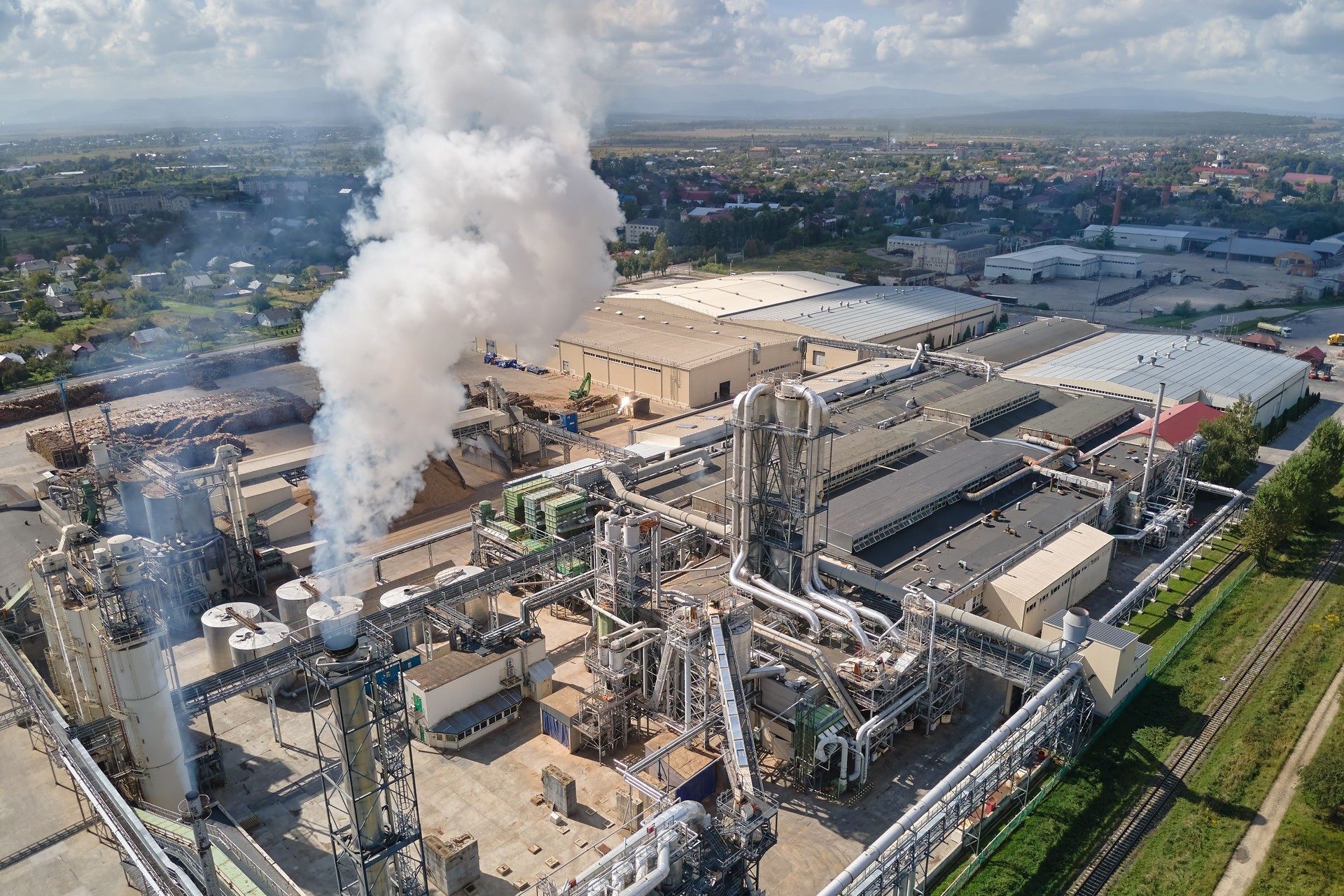 Aerial view of oil and gas refining petrochemical factory with high refinery plant manufacture structure. Global production and manufacturing concept.